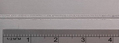 Figure7: Butt weld of 300μm thick sheets of aluminium alloy - Detail of top surface of a 2.0 mm width weld line 
